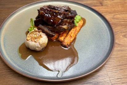 Beef ribs with baked carrots and wine-vegetable sauce