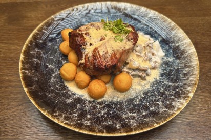 Grilled pork neck with fried mushrooms and mini potatoes